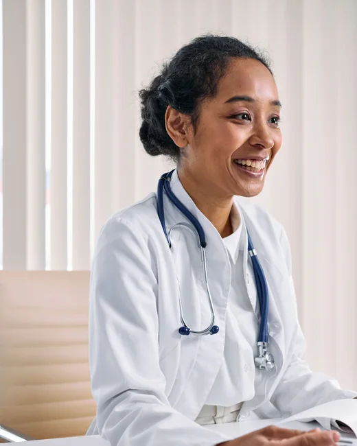 A physician in a white coat and stethoscope