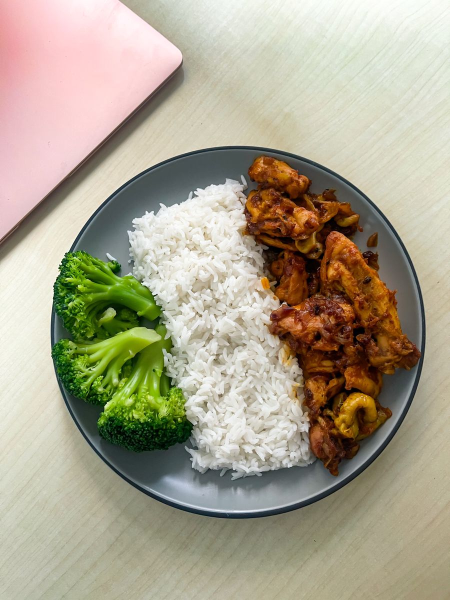 A plate of chicken, rice and broccoli seen from above