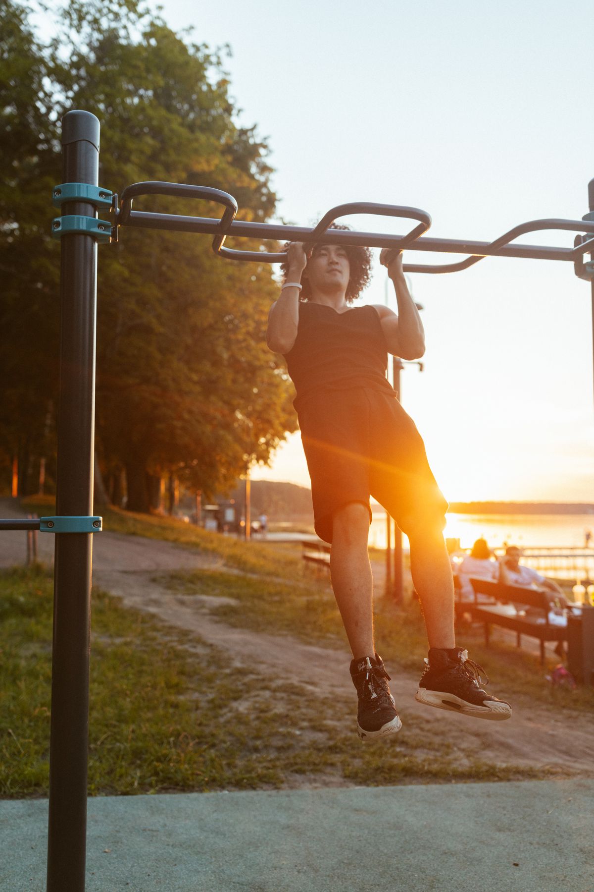 A pull-up on an outdoor bar at sunset