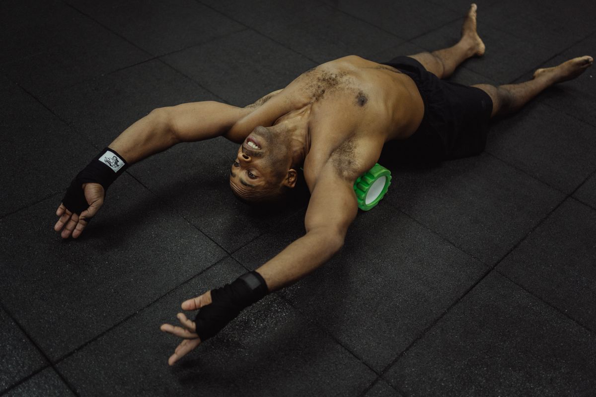 Foam rolling on a gym floor