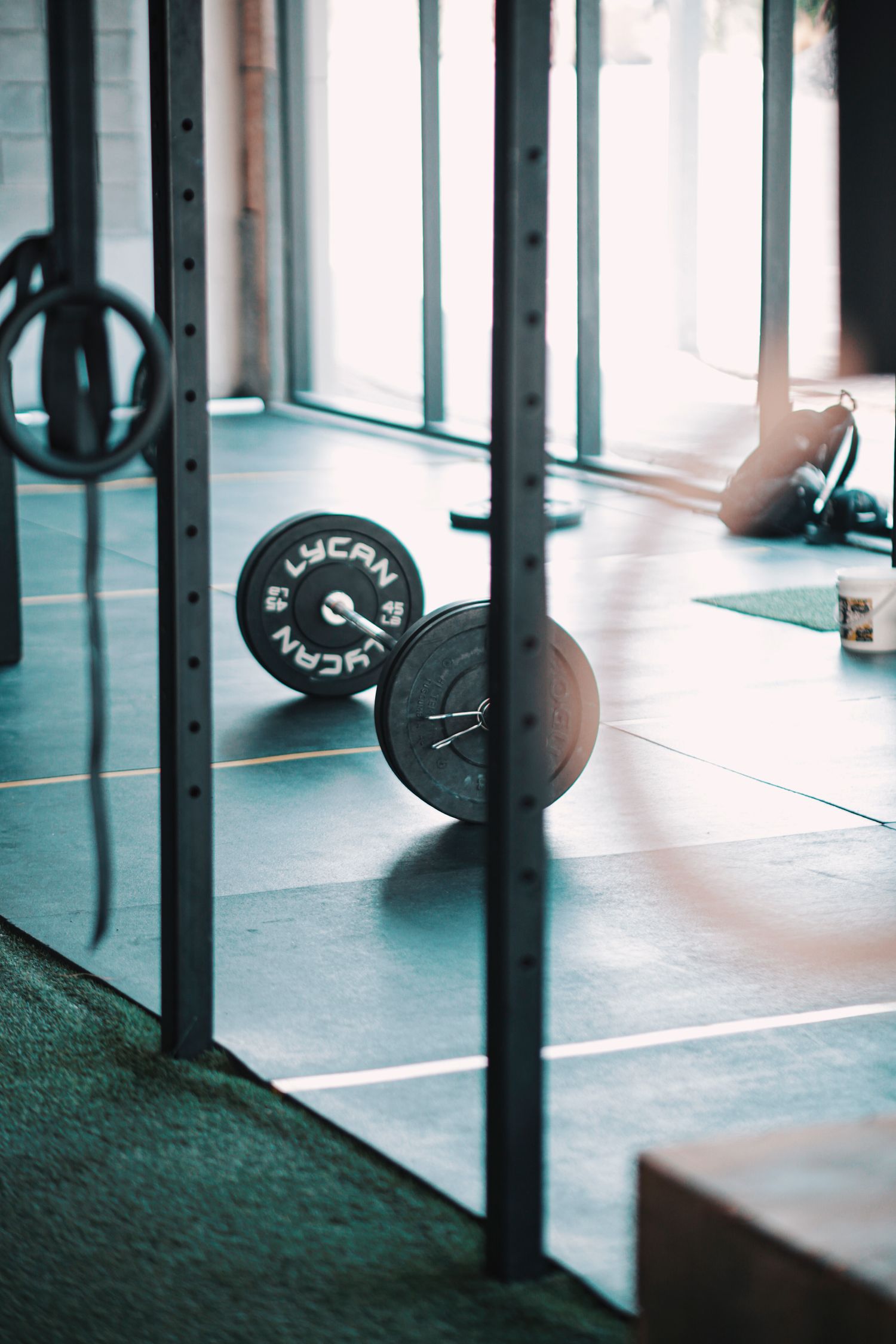 A barbell left alone on a gym floor